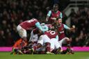 West Ham players pile on to celebrate Angelo Ogbonna's winner. Picture: Action Images