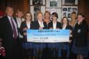 Pupils present the cheque to Haven House