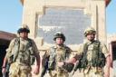 HISTORIC: Lieutenant Mark Taylor (centre) with members of his platoon in front of a First World War memorial in Basra