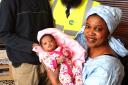 Fatim Faye holding baby Rakhy Giene Deme, proud father Ndiogou Deme, left, and bus driver Sajjad Shariff