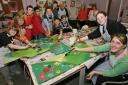 Volunteers and pupils busy painting for the sensory garden at Oak View School