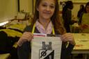 Pupil Alannah Peskit with a West Hatch High School bag