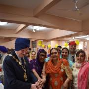 A birthday cake is cut to mark the 40th anniversary of the Gurdwara Sikh Sangat in Francis Road, Leyton. Photo: Wendy J Smith