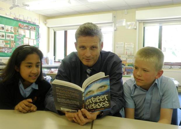Joe Layburn with two former year 6 pupils, Rohini Datta and Tom Mead, reading his Tower Hamlets Children's Award-winning novel Street Heroes