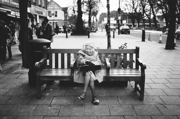 Woman on a bench on Wanstead High Street
