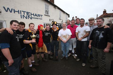 Teams from the Nag's Head and White Hart pubs in Moreton take part in there annual Boxing Day tug of war. (26/12/2012) EL33943-1