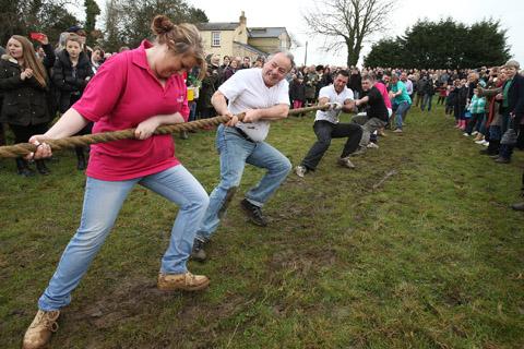 Teams from the Nag's Head and White Hart pubs in Moreton take part in there annual Boxing Day tug of war. (26/12/2012) EL33943-4