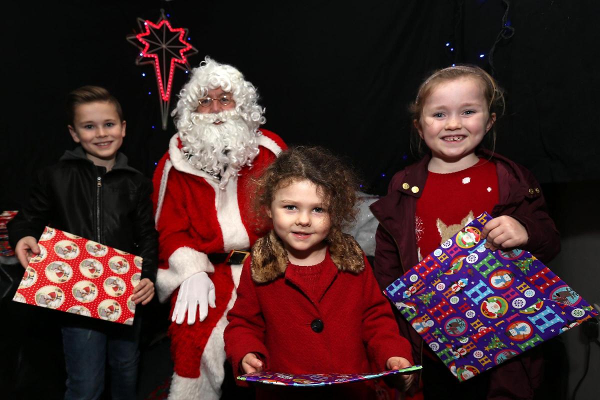Oliver and Loly Bedford and Matilda Sampson meet Santa in his Grotto at Epping Fire Station during Christmas Market in the High Streetin Epping, Essex. (4/12/2015) EL86285_4