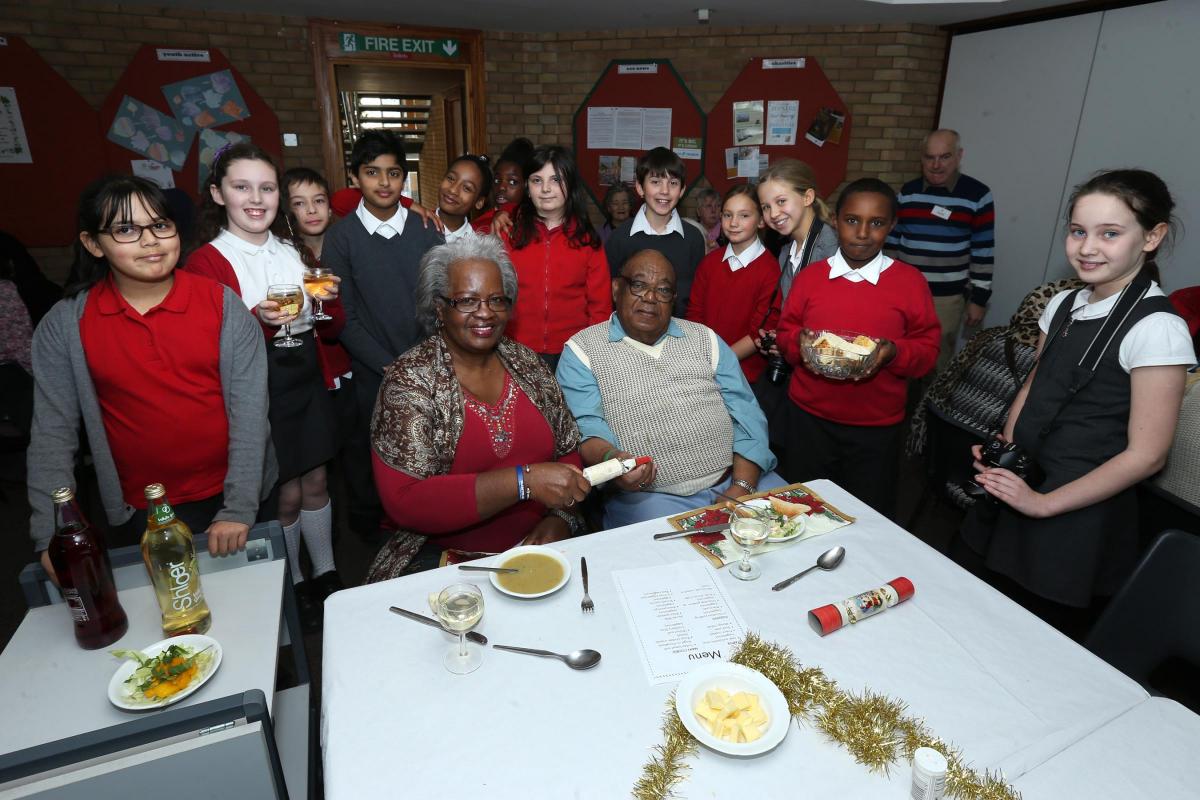 Gywn Jones Primary students from year 6 serve Daphne and George Crooks during 
Leytonstone United Free Church Christmas meal for local elderly and disabled residents. Leytonstone. (9/12/2015) EL86369_2