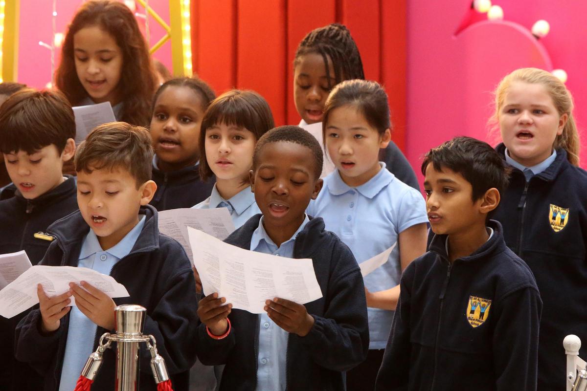 School choirs from Davies Lane Primary School and Selwyn Primary School sing to shoppers in the Mall in support of the Mayor's appeal. Walthamstow. (11/12/2015) EL86424_2