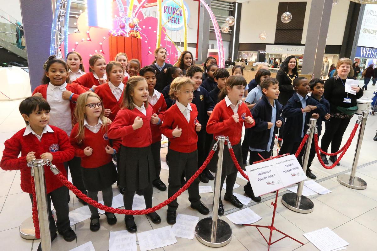 School choirs from Davies Lane Primary School and Selwyn Primary School sing to shoppers in the Mall in support of the Mayor's appeal. Walthamstow. (11/12/2015) EL86424_5