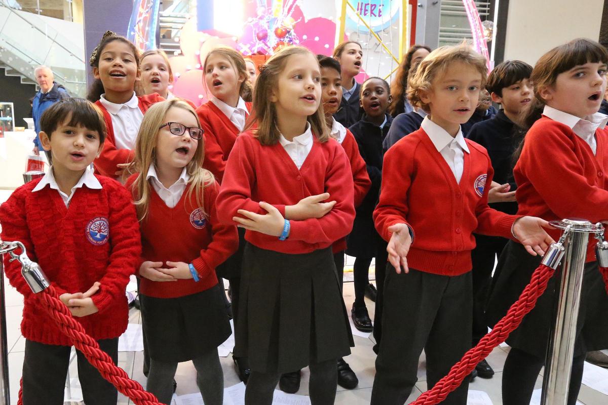 School choirs from Davies Lane Primary School and Selwyn Primary School sing to shoppers in the Mall in support of the Mayor's appeal. Walthamstow. (11/12/2015) EL86424_4