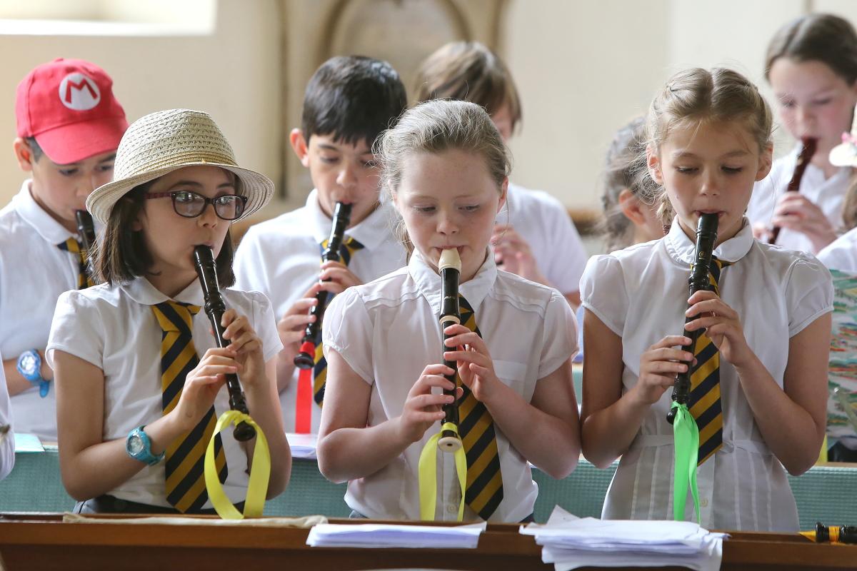 Children from local schools taking part in a Recorder Festival rehearse before an evening performance at St Mary's Church, South Woodford. 