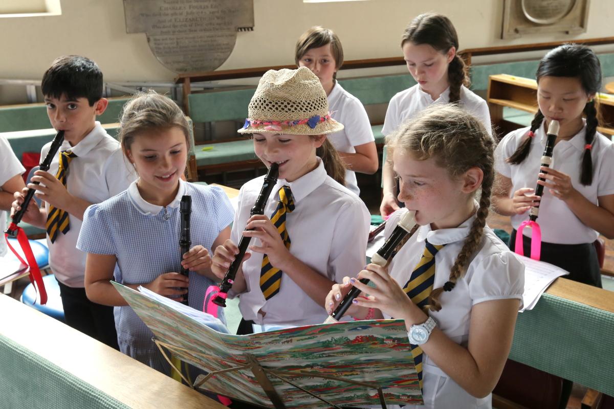 Children from local schools taking part in a Recorder Festival rehearse before an evening performance at St Mary's Church, South Woodford. 