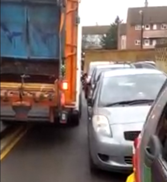 A bin lorry squeezing past parked cars on The Drive in January 2021 (WF Council)