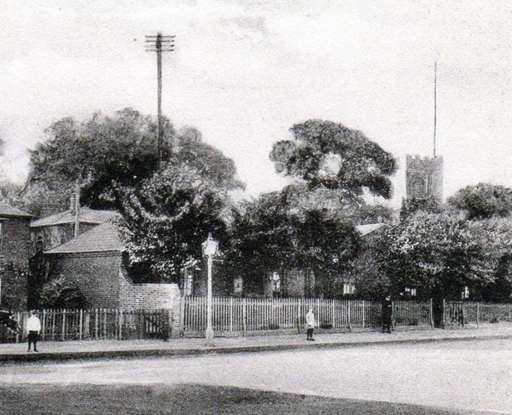 Church End in 1904. The almshouses are obscured by trees