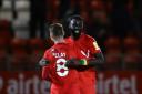 Leyton Orient's Craig Clay and Ousseynou Cisse celebrate at the end of the Sky Bet League Two match at the Breyer Group Stadium, London.