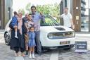 Mohammed Idrisnur with his family and new e-car