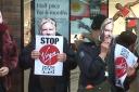 Protesters wearing Richard Branson masks outside the Virgin Media shop in Walthamstow