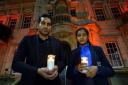 Wilson Chowdhry and his daughter Hannah with candles in honour of Asia Bibi who was acquitted after years inprison in Pakistan.