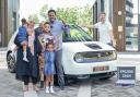 Mohammed Idrisnur with his family and new e-car