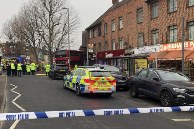 Emergency services in Selwyn Avenue. The crashed bus is in the background. Credit: PA