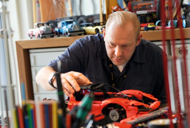 East London and West Essex Guardian Series: A man assembling the LEGO Technic Ferrari Daytona SP3. Credit: LEGO