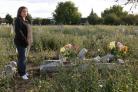 Cheryl Johnston beside her sister's grave.