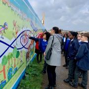 Children from St Joseph’s Catholic Junior School pointing out their favourite parts of the artwork.