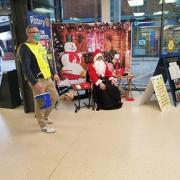 Father Christmas helping a Rotarian with a collection at Tesco