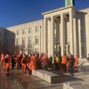 Urbaser workers turned their backs to the camera to protect their identities while protesting outside Waltham Forest Town Hall. Image: Local Democracy Reporting Service