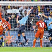 Luis Suarez palms the ball away in the dying moments of Uruguay's quarter-final clash with Ghana