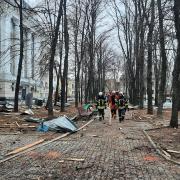 Firefighters survey the devastation caused by a missile strike in Kharkiv. Picture: PA