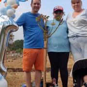 Gemma Parry, her partner Dean, their son Archie, and Gemma's daughter Kaylea at the cemetery to mark what have been Ronnie's first birthday. Image: Barking, Havering and Redbridge University Hospitals NHS Trust