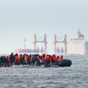 A group of people thought to be migrants crossing the Channel from the coast of France and heading in the direction of Dover (Image: PA)