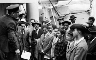 Jamaican immigrants welcomed by RAF officials from the Colonial Office after the ex-troopship HMT 'Empire Windrush' landed them at Tilbury (Image: PA)