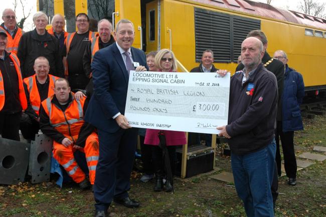 Nigel Holness, the Managing Director of London Underground, presenting a cheque to Poppy Appeal Organiser John Duffell